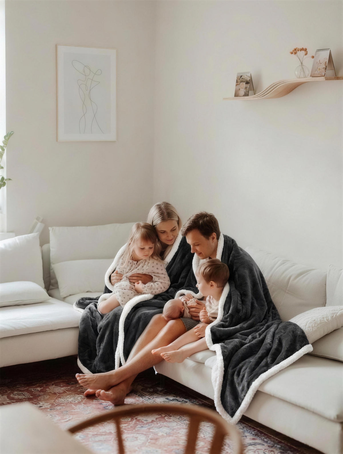 Family with kids sharing Kokoon heated blankets on the sofa